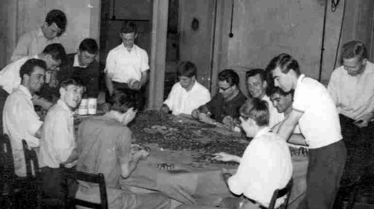 Ballroom Counting Sep '61:
This shows the proceeds of the 1961 carnival collecting tins
being counted in the hostel ballroom.
Proceeds were �280.00.
Roy snook, Brian Holdstock, 'Booze' Green, 'Spag',
Norman Sheen, Sid Marsh, John Ashley, Bill Finch
and a number of other guys from 55/56 intake