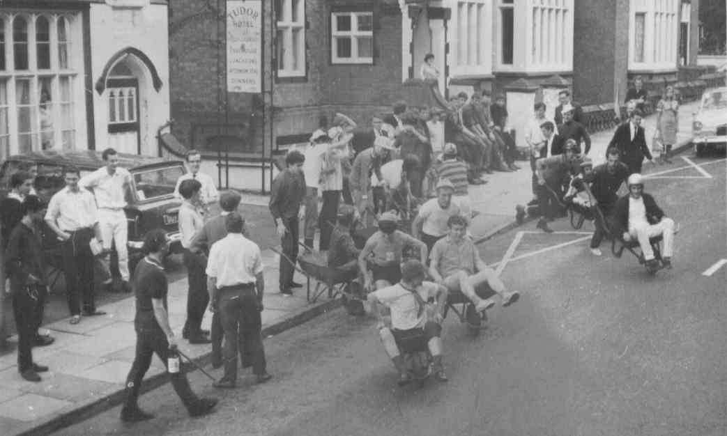 Wheelbarrow race:
Start at Tudor hotel with first pusher downing half pint then running to
next pub where passenger (terrified) leapt out for a gulped half pint
then swapped pushing to next pub and so on to exhausting finish.
Course ran down to Link top and back along Orchard road.
Downing beer quickly and pushing our superb physiques to the limit.