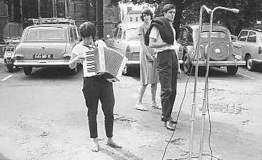 I don't know the musician but it is
MikeThomas and rosalyn behind the Mike! 